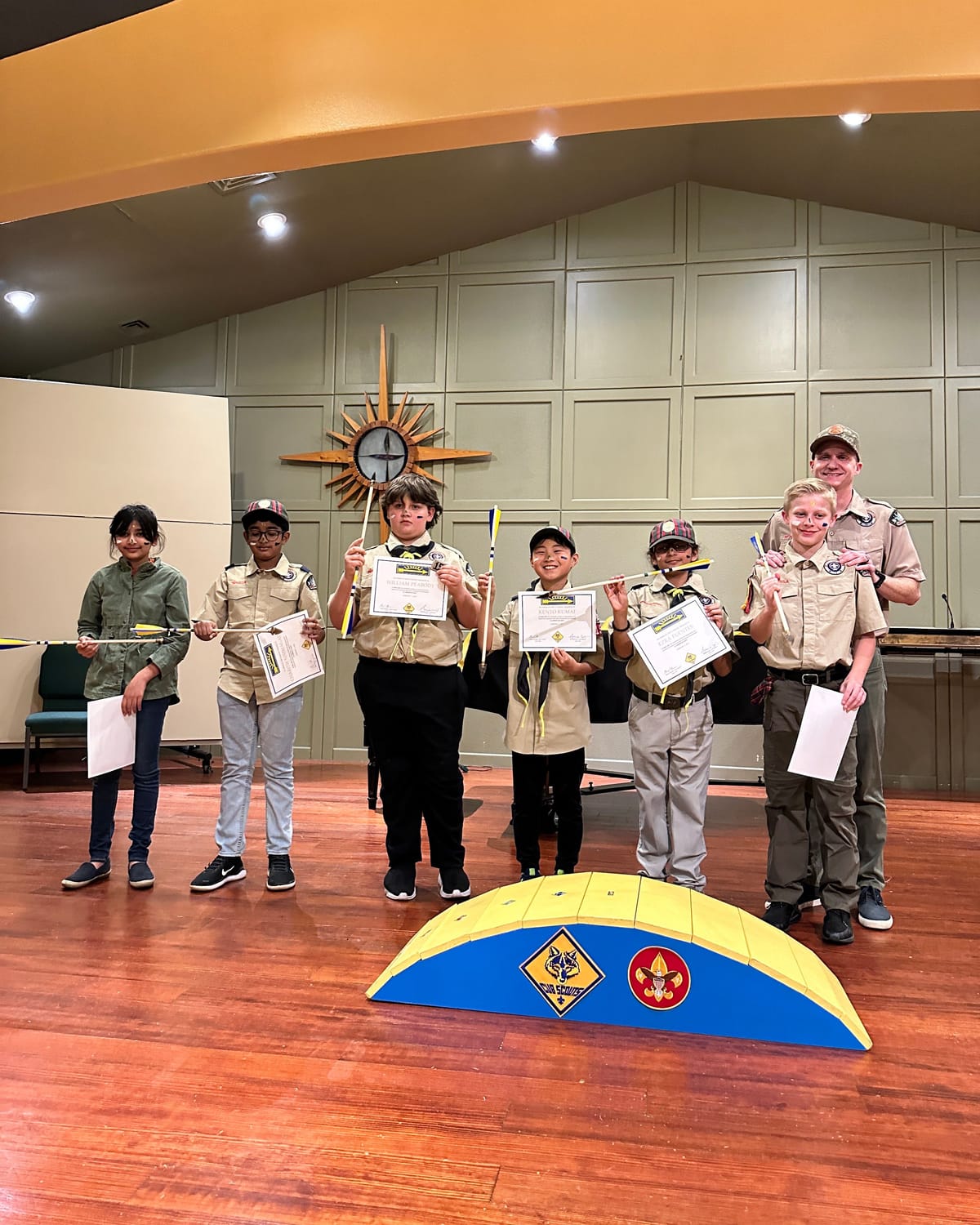 Viti holding her Arrow of Light arrow with fellow scouts at the crossover ceremony