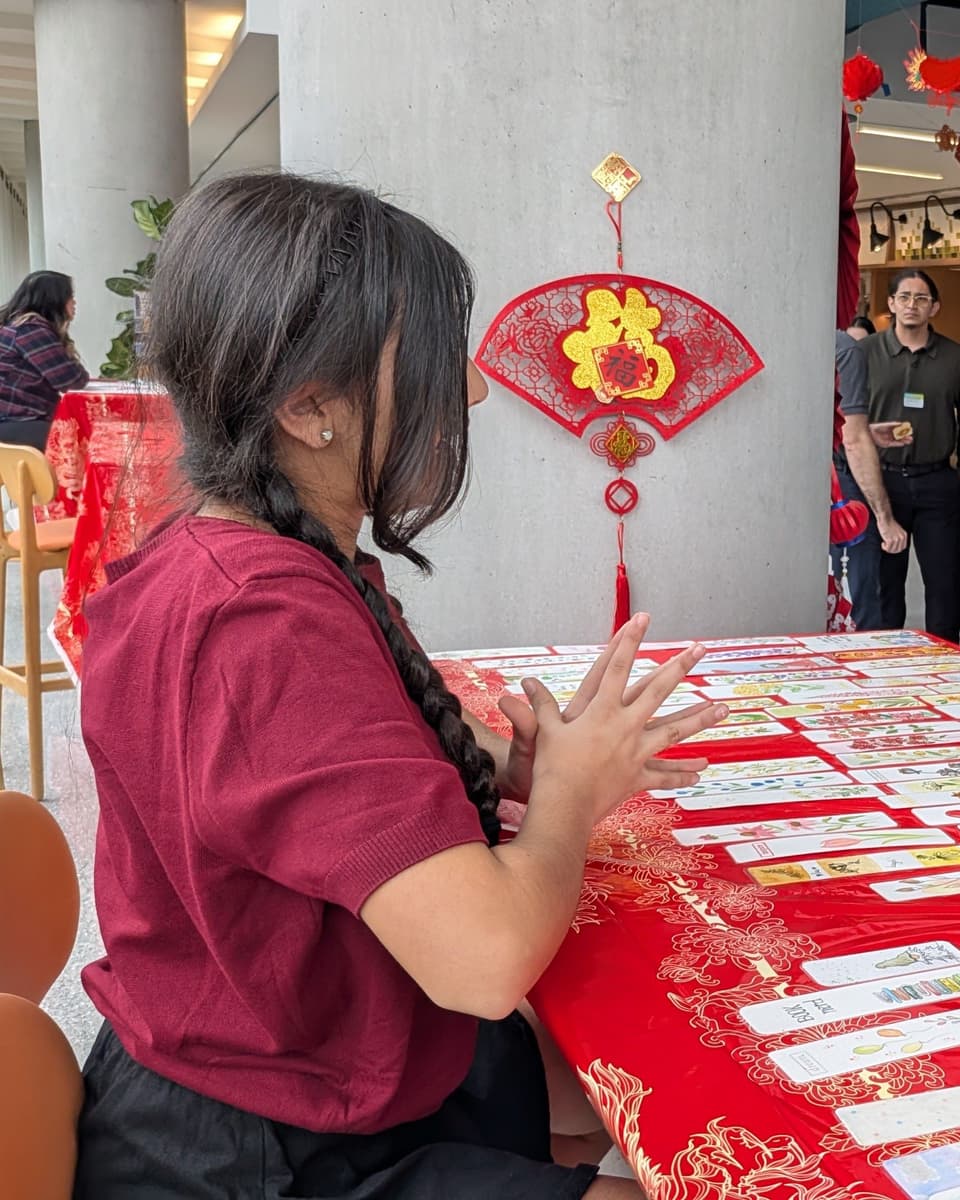 Viti at her table of handmade bookmarks beneath a red Lunar New Year decoration