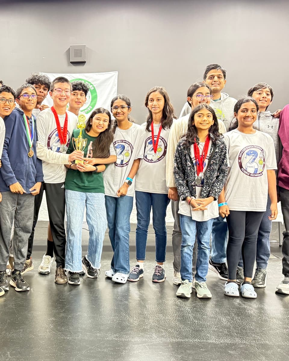 Viti with her medal among her Science Olympiad teammates holding the winning trophy